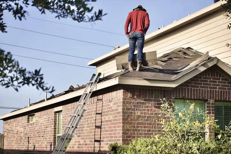Professional roofer working on a residential roof in Triangle Estates